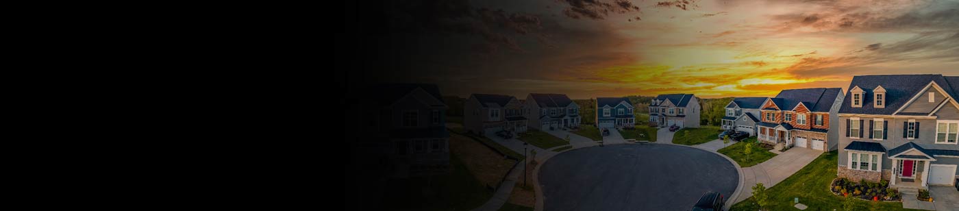 an aerial picture of houses around a cul de sac at sunset